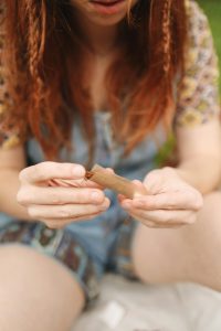 A lady rolling her joint