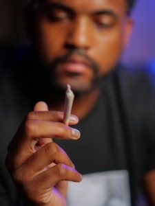 A man holding a joint