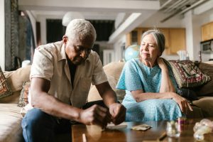Seniors sitting by a wooden table