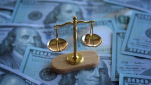 balancing scale on top of money
