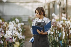 a farmer taking record of plant progress