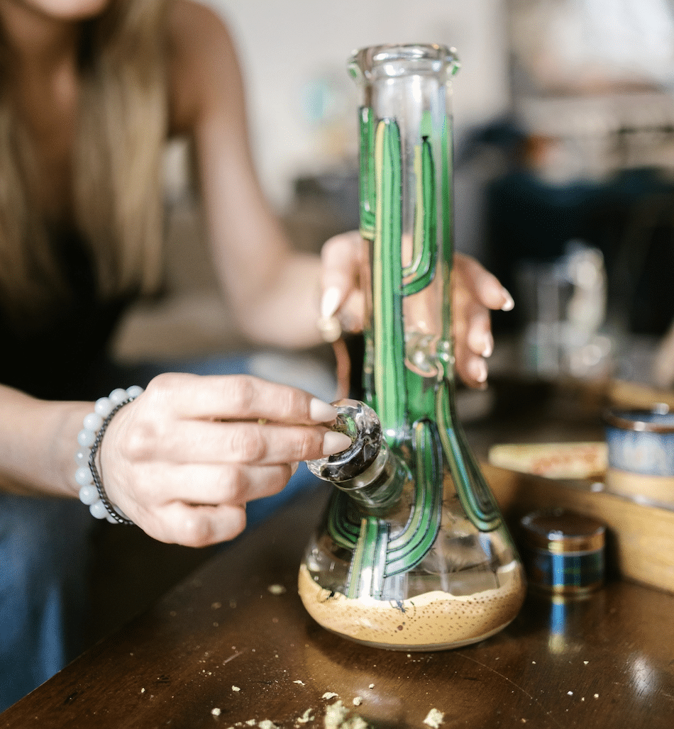 woman packing the bowl of a bong
