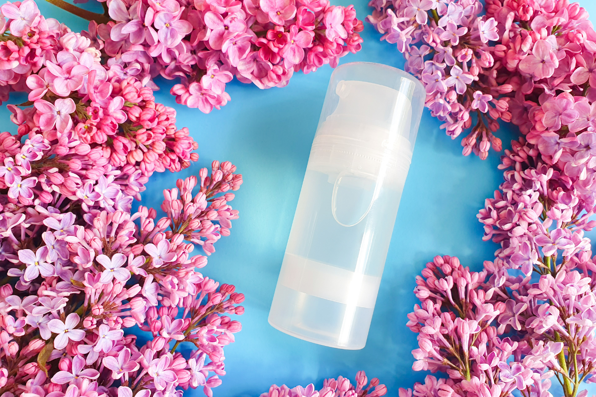 bottle of lube surrounded by flowers