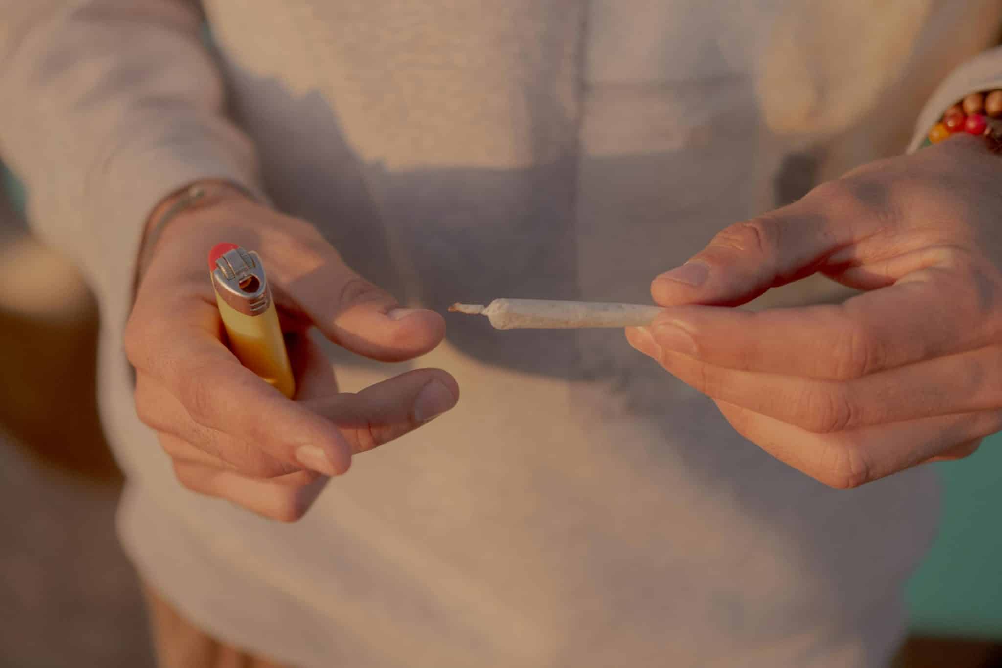 wedding cake strain person holding a joint