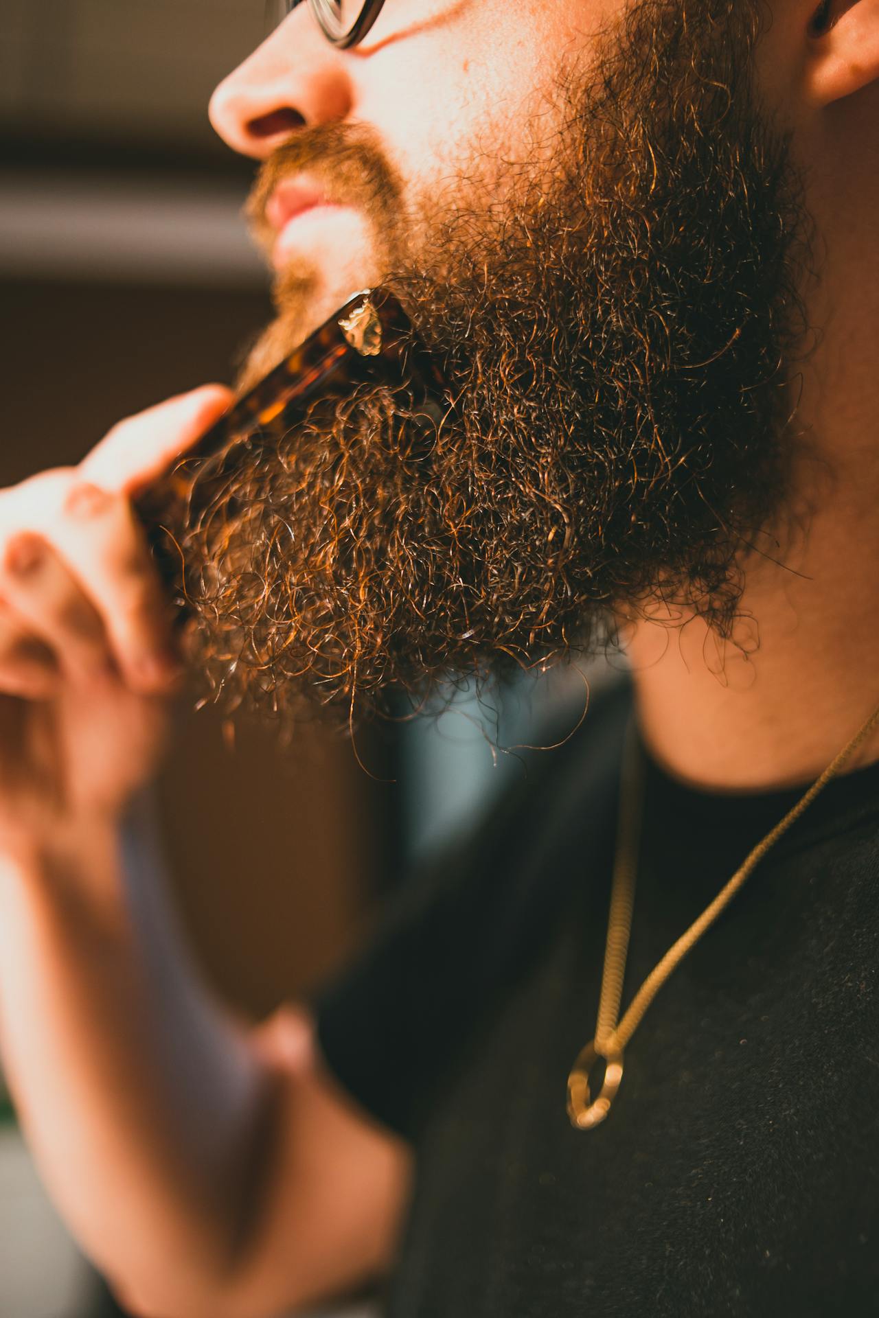 man grooming his beard cbd products